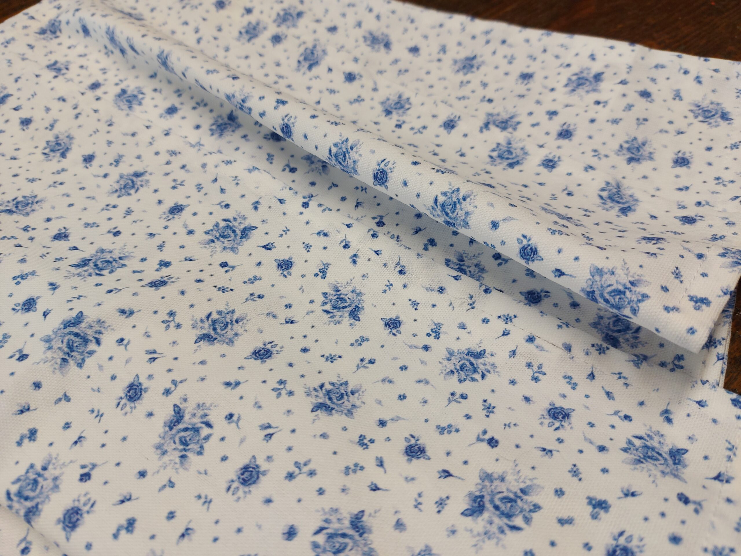 Blue roses on white cotton napkins
