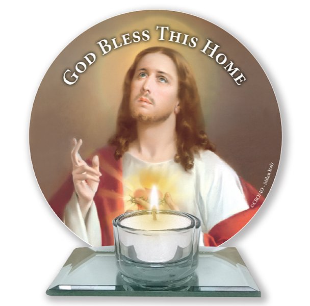 A glass votive light holder, with round image of the Sacred Heart.